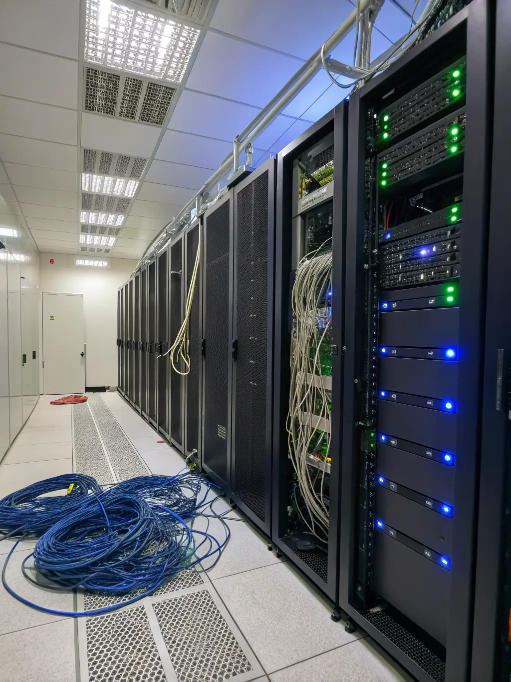 A professional photograph of a server room with blinking lights, symbolizing data protection and infrastructure security for Fox Data Tech.